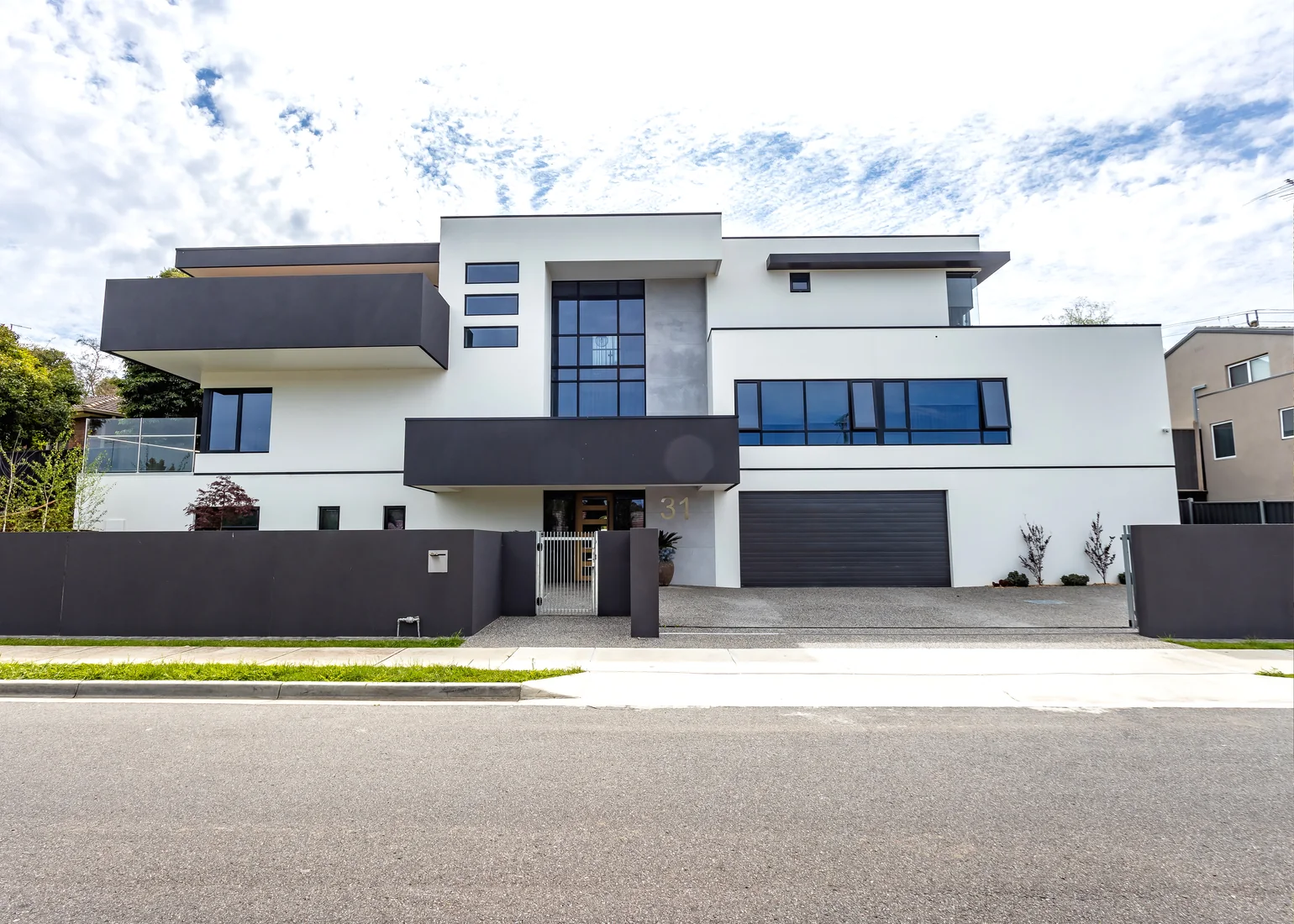 Contemporary two-storey residence with rendered facade.